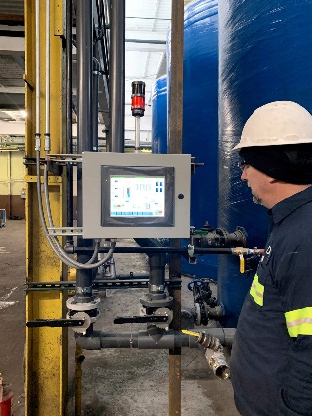 man operating storage tank controls 