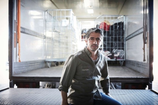 Man sitting on the back of a semi truck